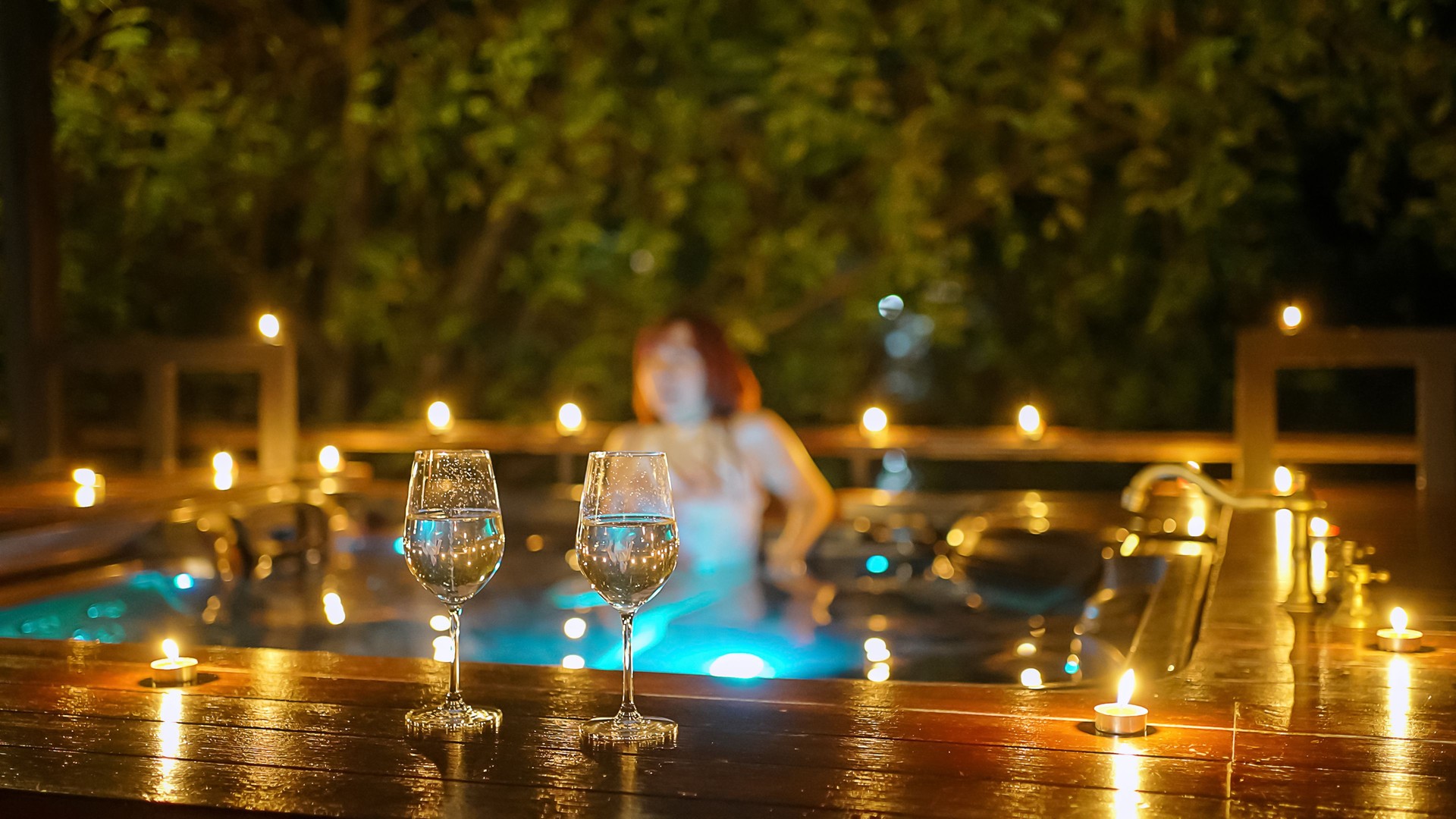 Wine glasses and Woman is at hot tub bath.